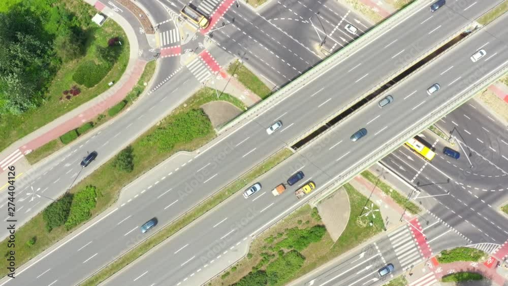 Aerial view of a freeway intersection. Clip. Highway and overpass with cars and trucks, interchange, two-level road junction in the big city. Top view Aerial view of a freeway intersection. Clip. Highway and overpass with cars and trucks, interchange, two-level road junction in the big city. Top view