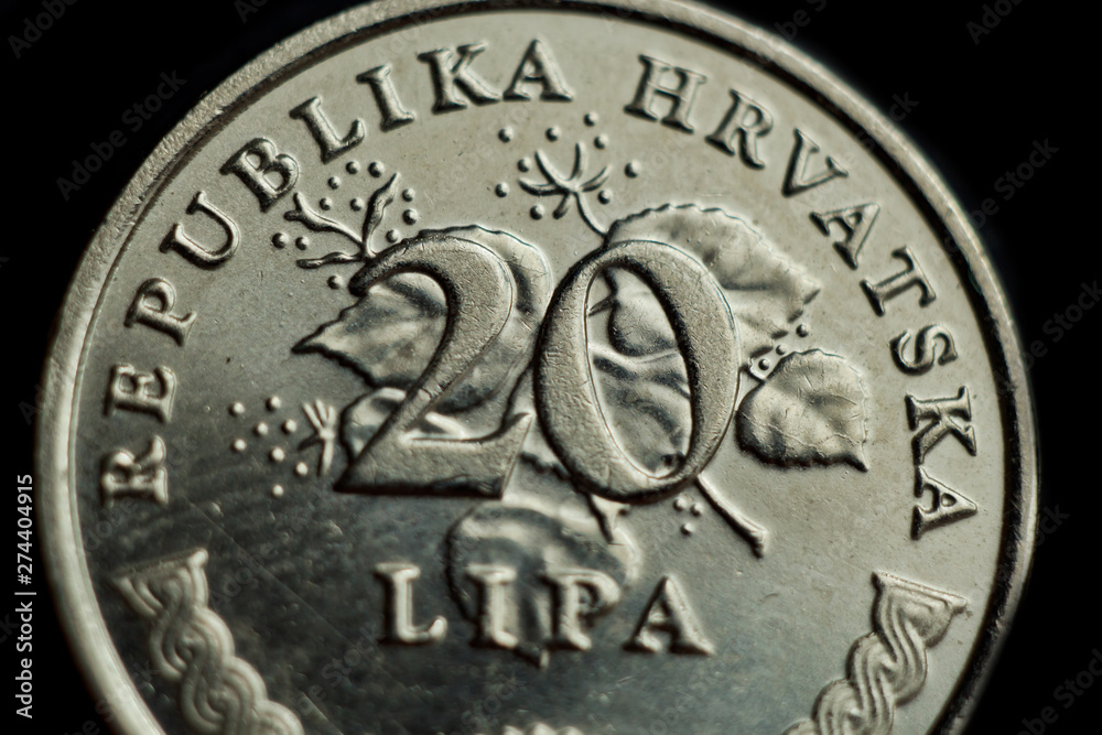 Naklejka premium coin twenty croatian lipa macro isolated on black background. Detail of metallic money close up. money of european country croatia