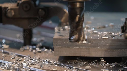 Milling machine in operation cutting steel in a high-tech machineshop close up photo