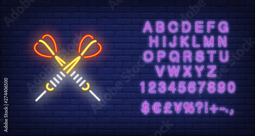 Two crossed arrow darts neon sign. Illustration of two darts on dark blue brick background. Can be used for topics entertainment, games, advertisement