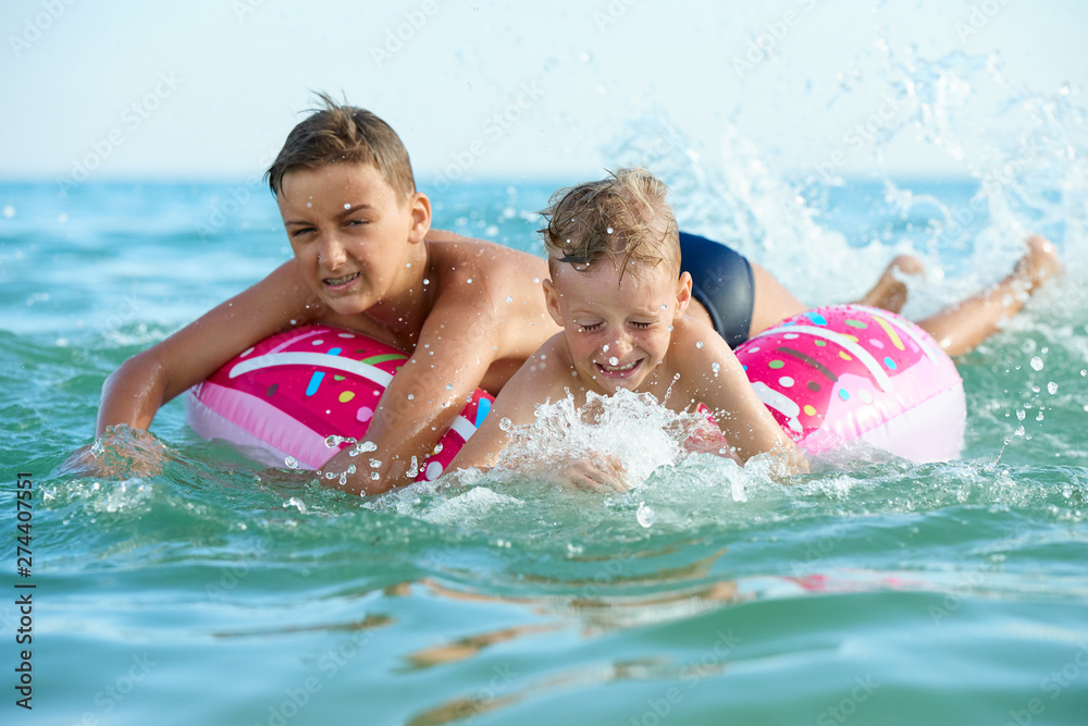 TWO BOYS SAVE ON A INFLATABLE CIRCLE AT SEA