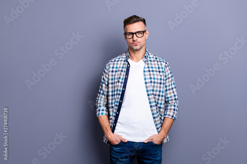 Close up photo intelligent he him his guy arms pockets reliable manager not smile self-confident self-assured person wear specs casual jeans denim plaid checkered shirt isolated grey background © deagreez