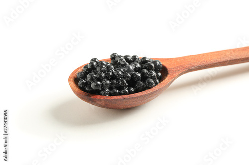 Spoon with black caviar isolated on white background, closeup