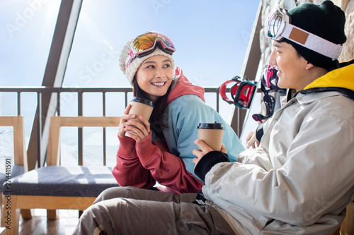 Happy young couple drinking coffee photo