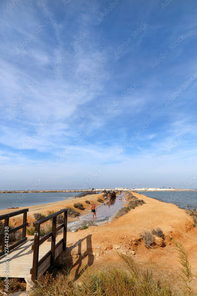 People having a mud bath in Los Barros. Mar Menor, Murcia, Spain