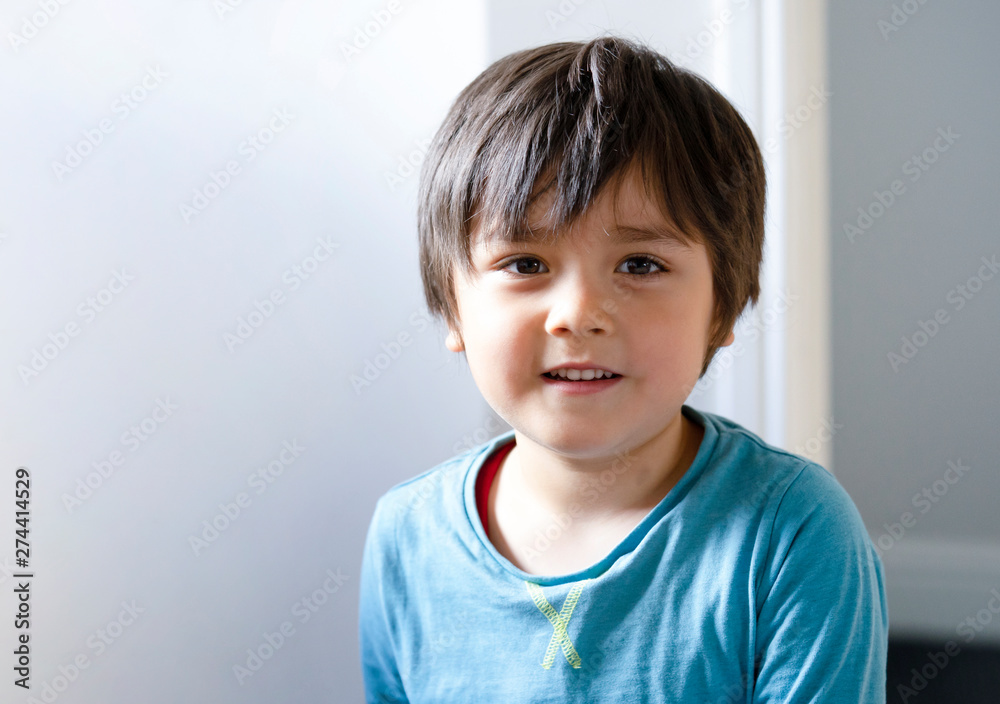 Indoor protrait of happy boy with bright light morning background, Hight key light of child standing next to the wall looking at camera with smiling face, Indoor protrait of happy boy with bright light morning background, Hight key light of child standing next to the wall looking at camera with smiling face,