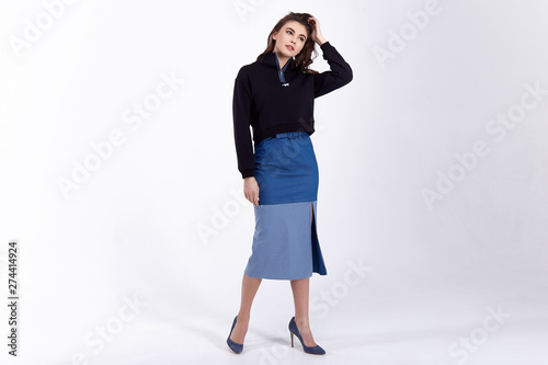 Sexy pretty fashion woman wear skirt sweater trend clothes collection catalogue long brunette hair party style model pose bright make-up beautiful face dress code office casual accessory shoes.