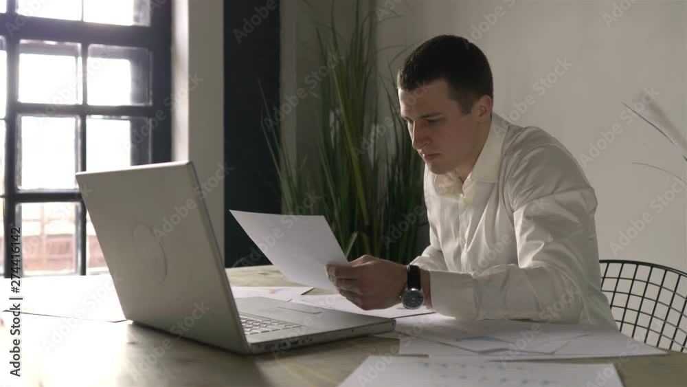 young businessman working with papers in the workplace