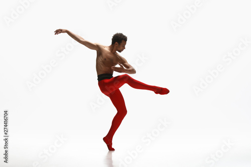 Graceful classic ballet dancer dancing isolated on white studio background. Man in bright red clothes like a combination of wine and milk. The dance  grace  artist  movement  action and motion concept