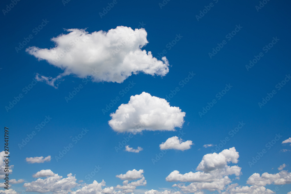 White, fluffy clouds in blue sky. Background from clouds. - obrazy, fototapety, plakaty 