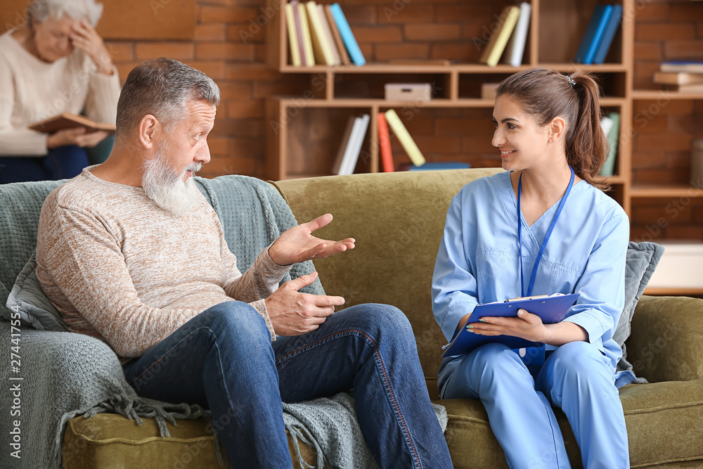 Elderly man with caregiver in nursing home Elderly man with caregiver in nursing home