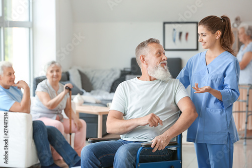 Elderly man with caregiver in nursing home