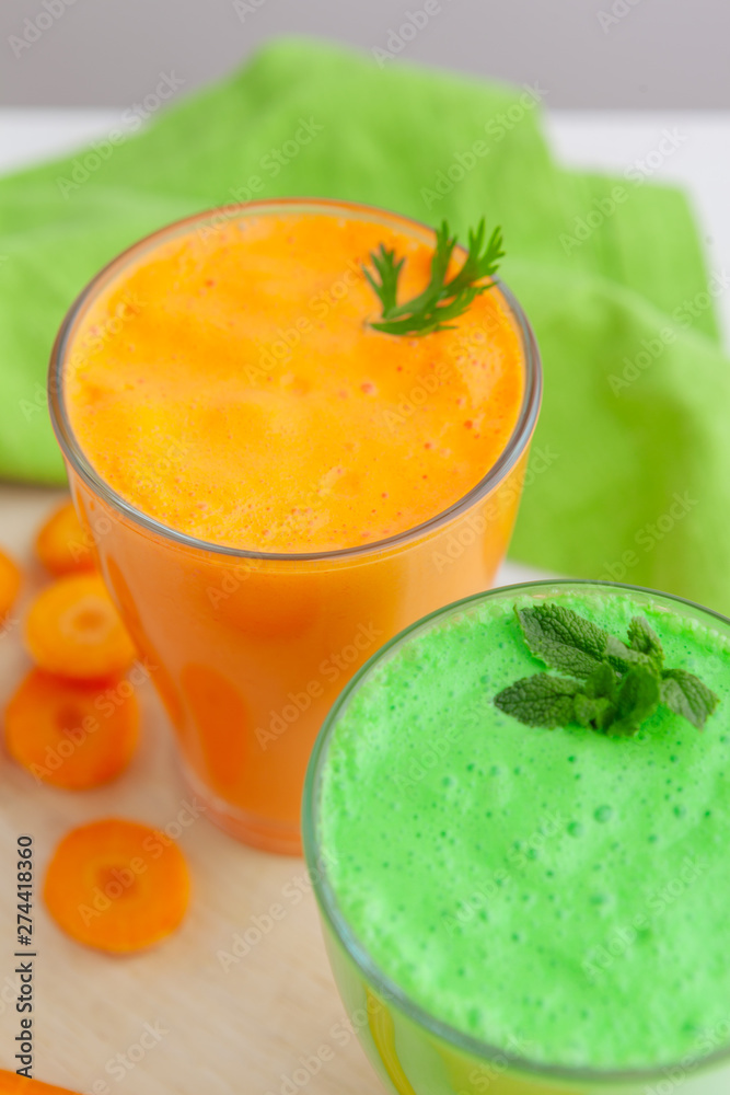 Green smoothie in glass over rustic wooden background Green smoothie in glass over rustic wooden background