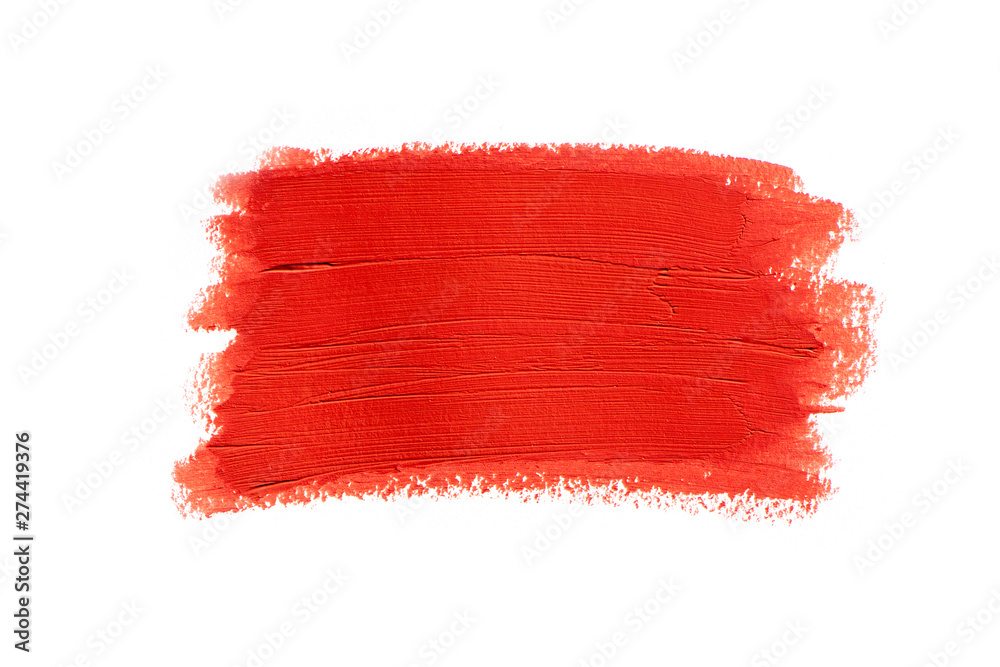Closeup smear of red lipstick isolated on white background.