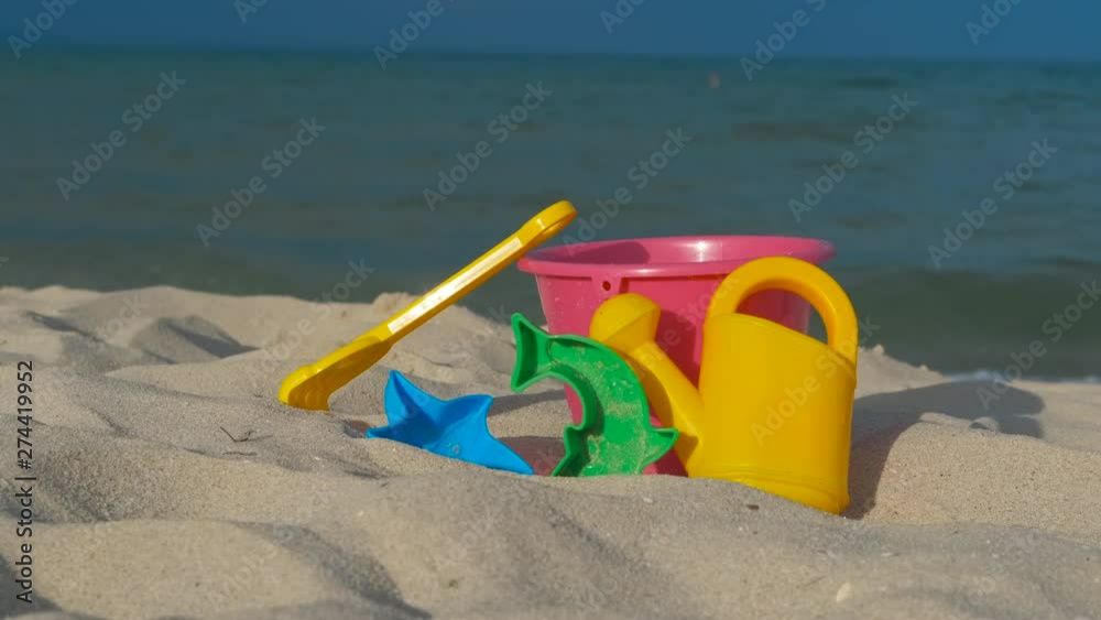 Children's toys on the beach. Children's toys for playing in the sand on the beach near the sea. Children's toys on the beach. Children's toys for playing in the sand on the beach near the sea.
