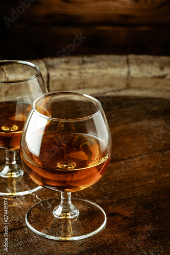 Two glasses of whiskey on a wooden table in the bar