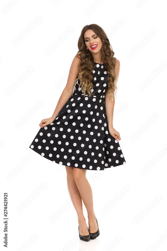 Beautiful Young Woman Is Posing In Black Cocktail Dress In Polka Dots Beautiful Young Woman Is Posing In Black Cocktail Dress In Polka Dots