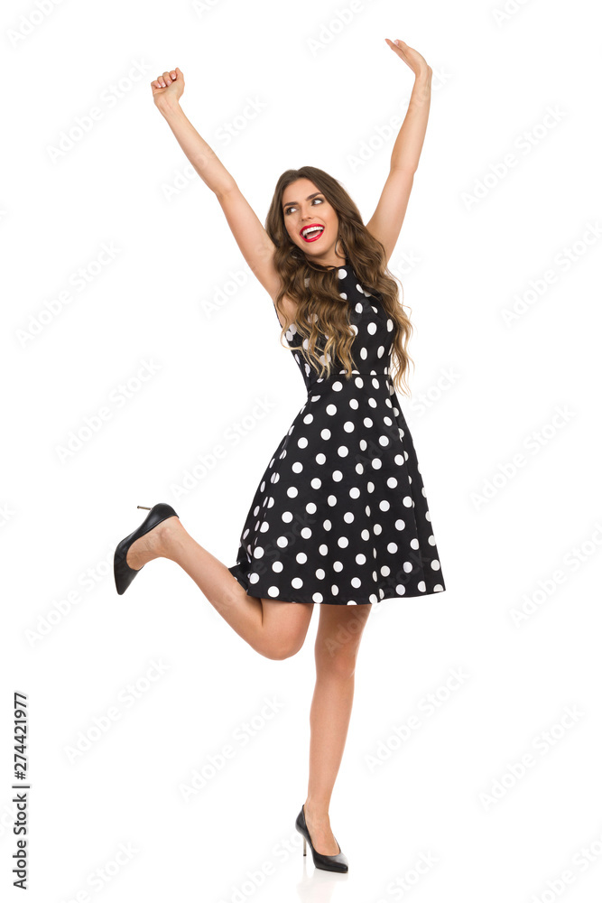 Carefee Woman In High Heels And Black Cocktail Dress Is Standing On One Leg Carefee Woman In High Heels And Black Cocktail Dress Is Standing On One Leg