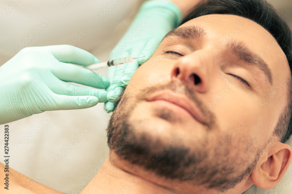 Close up of the vitamin injection into the facial skin Close up of the vitamin injection into the facial skin