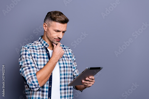 Portrait of his he nice attractive content concentrated focused bearded grey-haired guy wearing checked shirt searching web isolated over blue violet pastel background