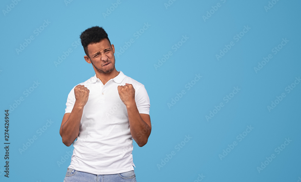 Black guy celebrating success near empty space