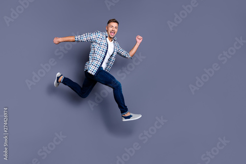 Portrait of attractive trendy millennial hurry move motion energy vacation holiday scream shout crazy dressed fashionable clothes isolatd grey background © deagreez