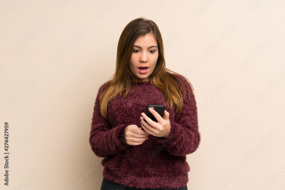 Young girl surprised and sending a message Young girl surprised and sending a message