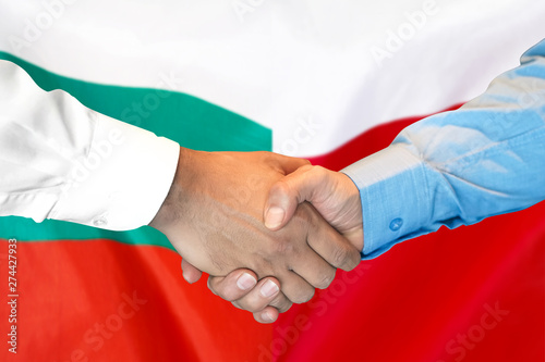 Business handshake on the background of two flags. Men handshake on the background of the Bulgaria and Poland flag. Support concept