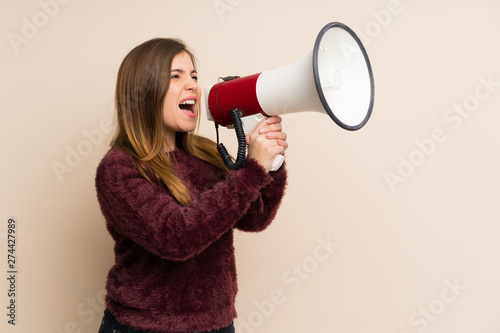 Young girl shouting through a megaphone