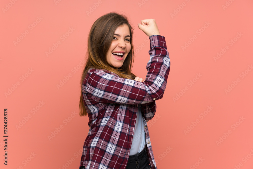 Young girl over pink wall doing strong gesture Young girl over pink wall doing strong gesture