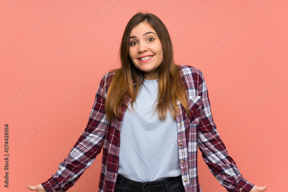 Young girl over pink wall smiling Young girl over pink wall smiling