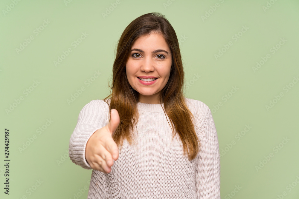 Young girl with white sweater handshaking after good deal Young girl with white sweater handshaking after good deal