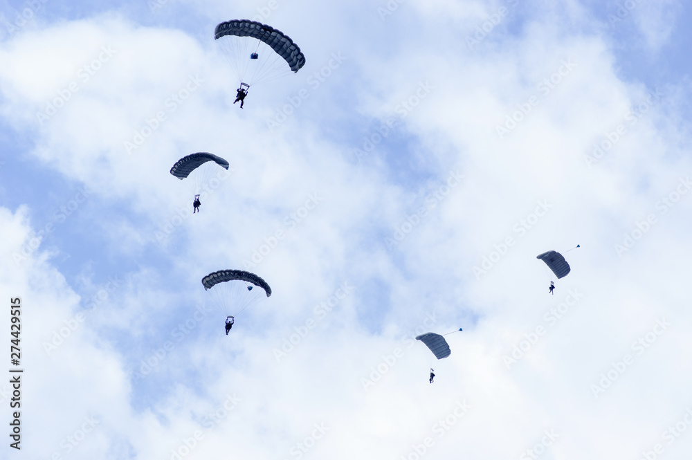 Military parachutists also called paratroopers in the sky with many clouds. Military parachutists also called paratroopers in the sky with many clouds.
