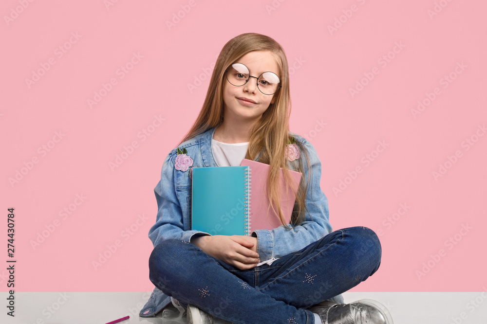 Confident schoolgirl with notepads Confident schoolgirl with notepads