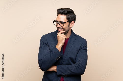 Handsome young man over isolated background looking to the side
