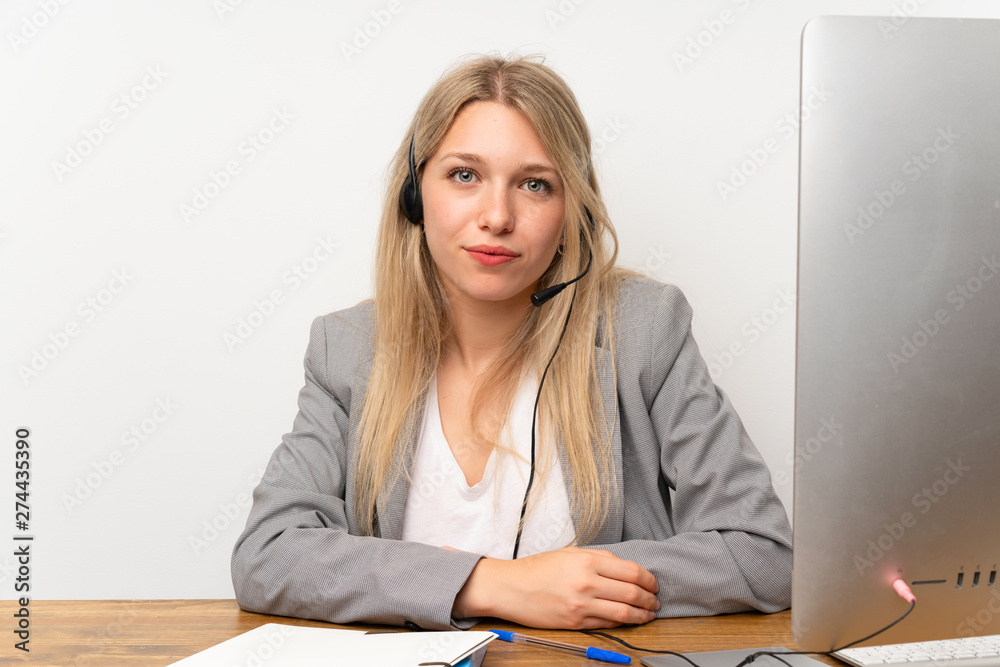 Young woman working with headset in a office Young woman working with headset in a office