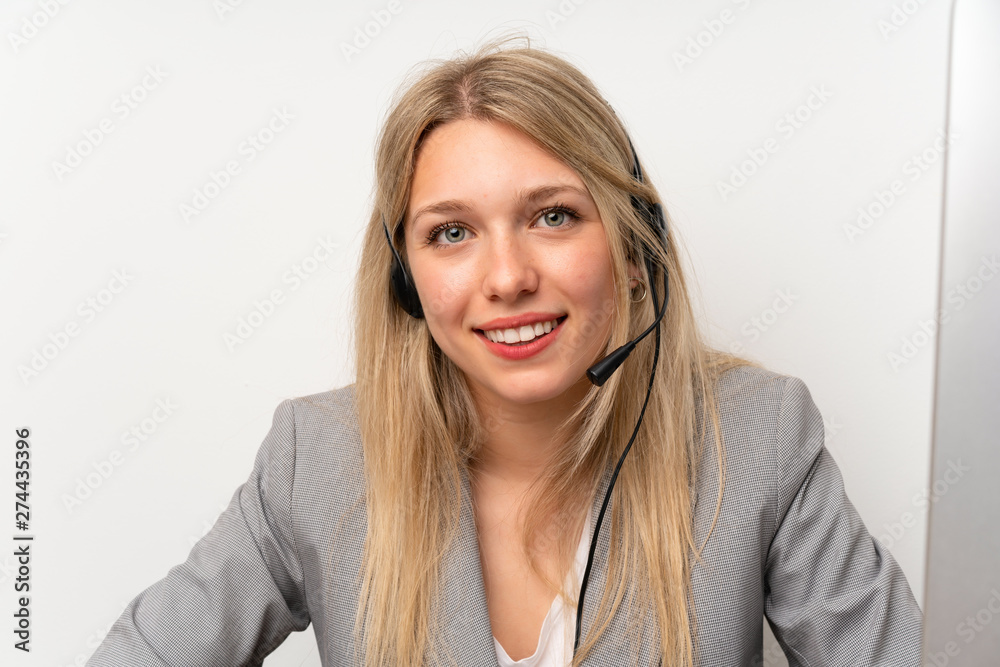Young woman working with headset in a office Young woman working with headset in a office