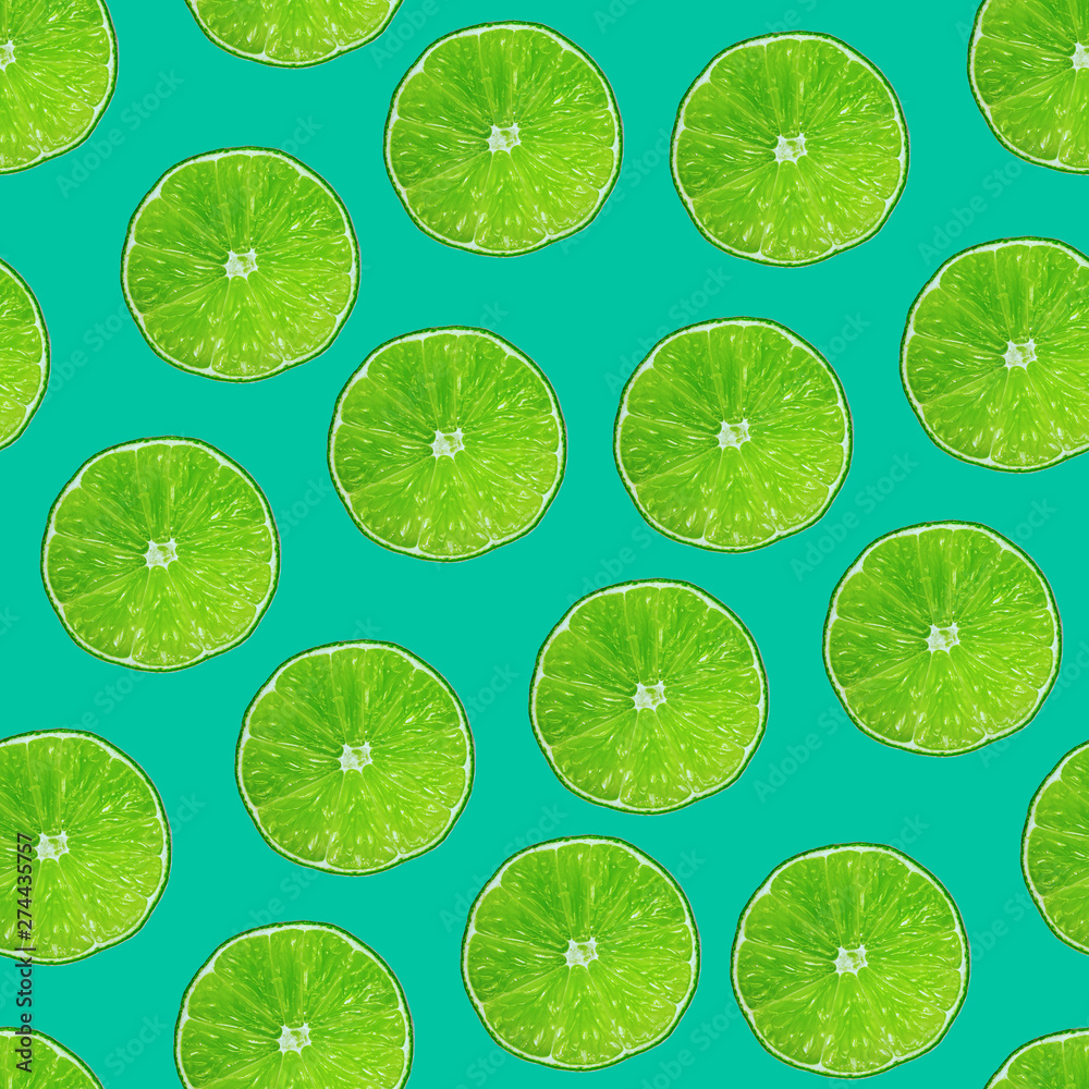 Lime slices on modern green background. Summer fruits seamless pattern. Limes texture design for textiles, wallpaper, fabric.