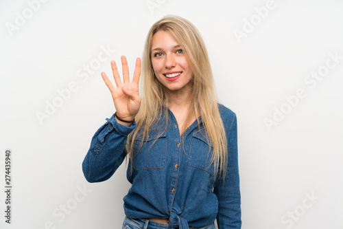 Young blonde woman over isolated white wall happy and counting four with fingers