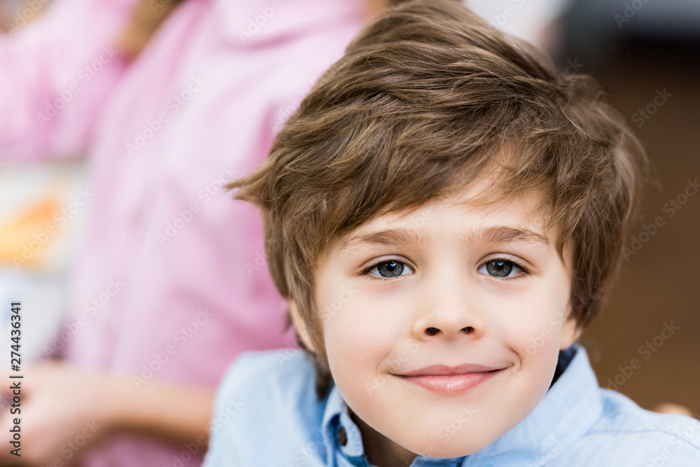 close up of cheerful child smiling while looking at camera close up of cheerful child smiling while looking at camera