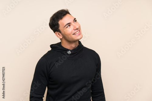 Handsome man over isolated background laughing and looking up © luismolinero
