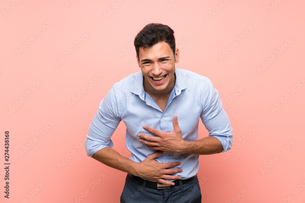 Handsome man over pink background smiling a lot Handsome man over pink background smiling a lot