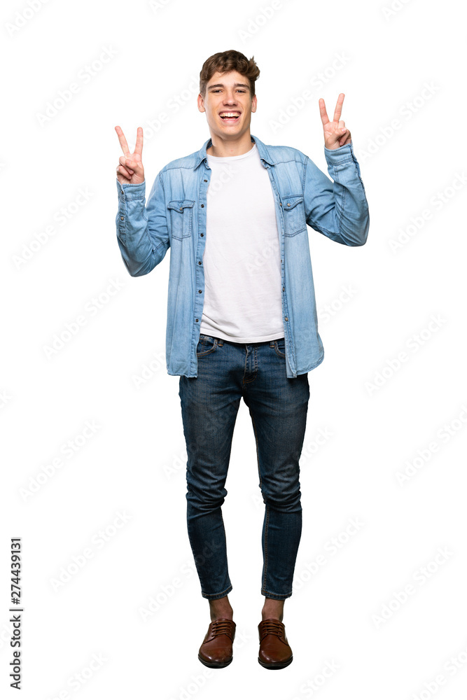 A full-length shot of a Handsome young man showing victory sign with both hands over isolated white background A full-length shot of a Handsome young man showing victory sign with both hands over isolated white background