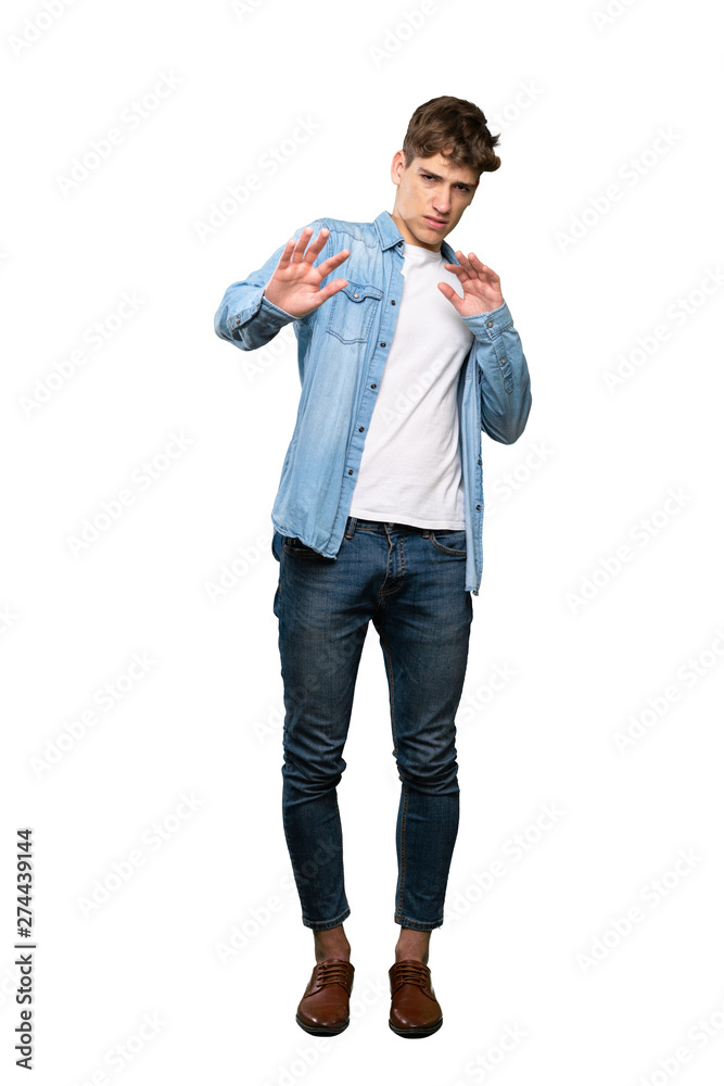 A full-length shot of a Handsome young man nervous stretching hands to the front over isolated white background A full-length shot of a Handsome young man nervous stretching hands to the front over isolated white background