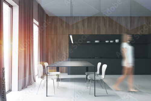 Woman in gray and wooden kitchen  curtains