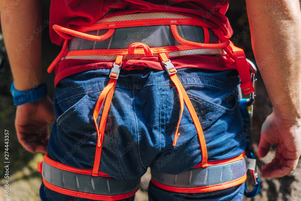 Detail close up poto of a climbing harness in bright colors. Front