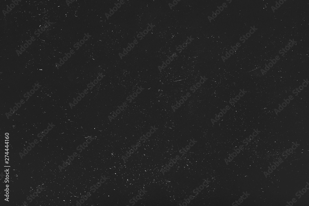Grunge distressed abstract background. White dust and scratches over black surface. Empty space.