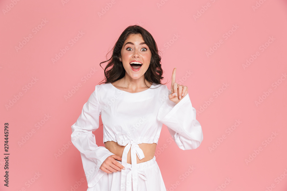 Excited shocked young pretty woman posing isolated over pink wall background. Excited shocked young pretty woman posing isolated over pink wall background.