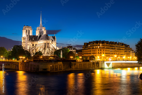 Seine river and Notre Dame de Paris at night in Paris, France.