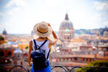 Rome Europe Italia travel summer tourism holiday vacation background -young smiling girl with mobile phone camera and map in hand standing on the hill looking on the cathedral Vatican